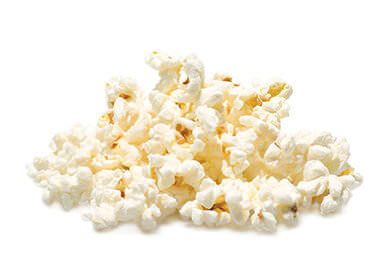 A pile of salted popcorn isolated on white background.