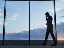 mature businessman with smartphone in a hotel P76RE6X