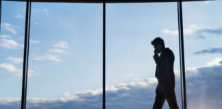 mature businessman with smartphone in a hotel P76RE6X