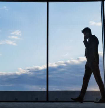 mature businessman with smartphone in a hotel P76RE6X