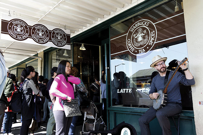 SEATTLE, WA - MAY 06, 2012: the first Starbucks coffee company store with its original sign design is located at the market in Seattle, Washington, USA