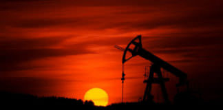 oil rig against red setting sun