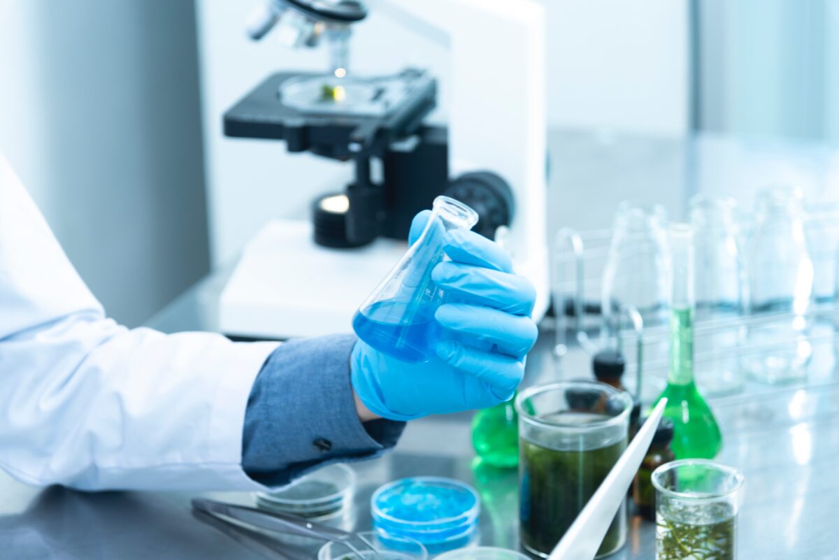 Lab technician mixing chemicals for article on potential of green ammonia