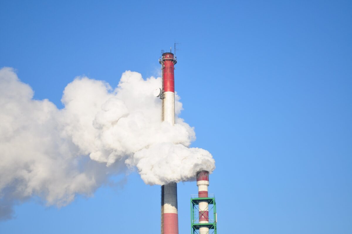 Is Carbon Capture and Storage the Answer to Decarbonization? picture of a smokestack for an article about what is carbon capture and decarbonization