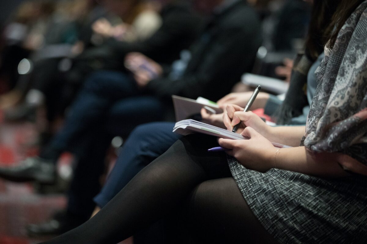 writing notes at a climate conference